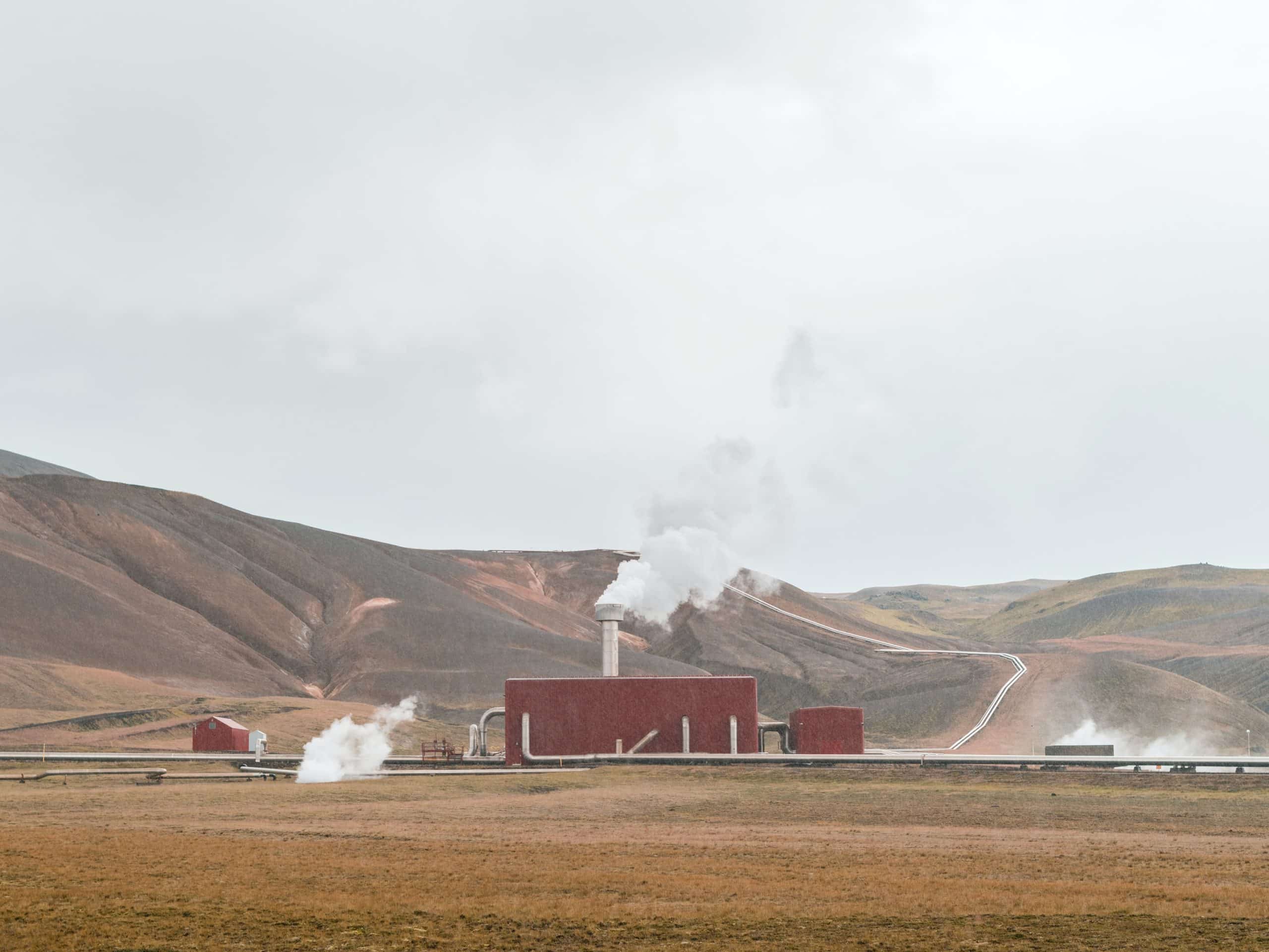 Geothermal power plant with mountains in the background
