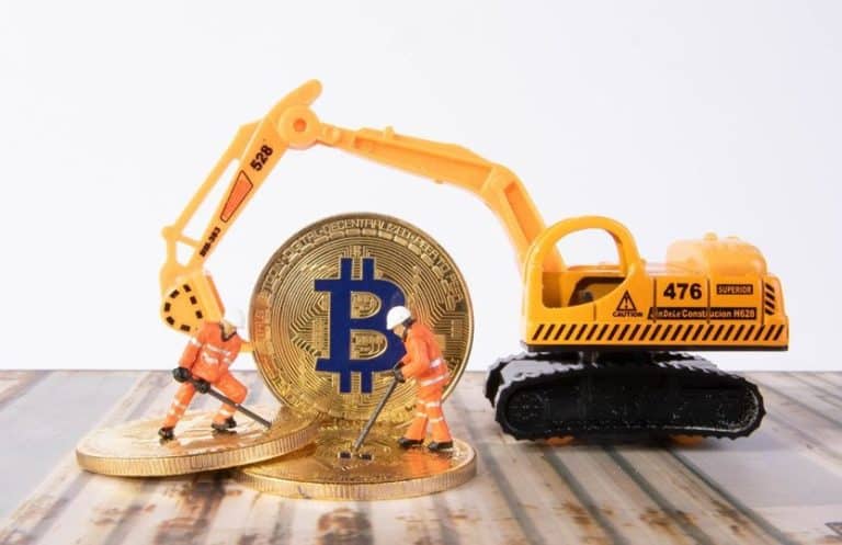 An excavator mining bitcoins with small action figures